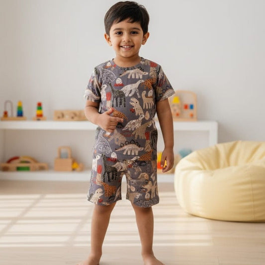 Child wearing a patterned outfit in a room with toys and a bean bag.